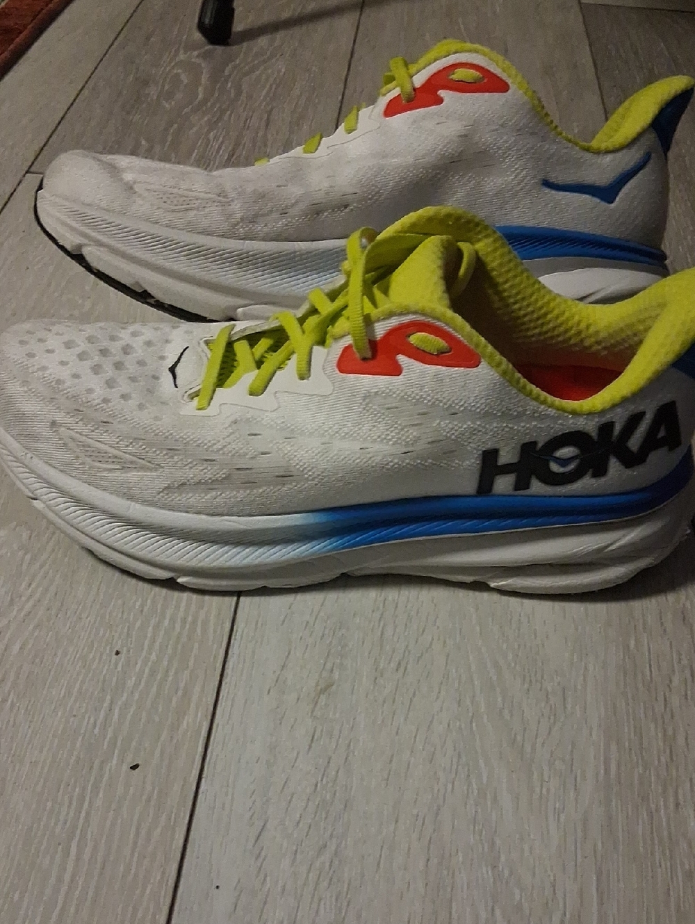 Hoka White Shoes with Yellow Liner and Blue Heel Accent